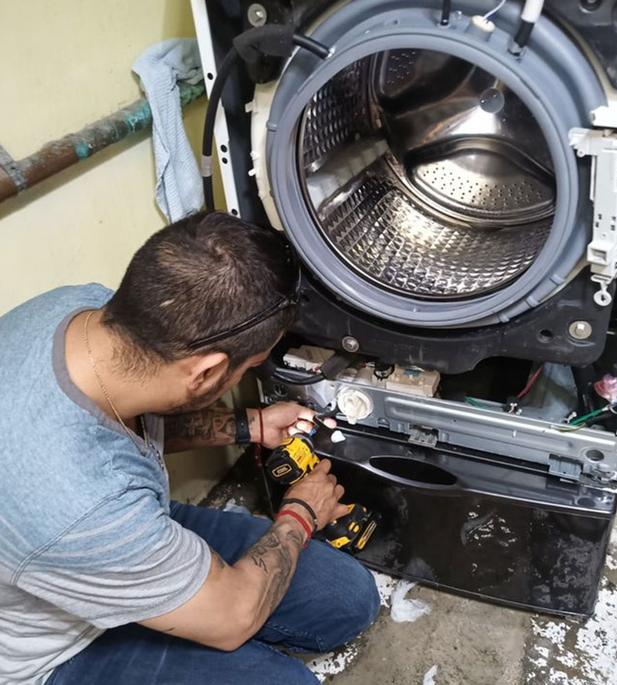 Appliance repair technician carrying a tool belt with screwdrivers, pliers and testing tools