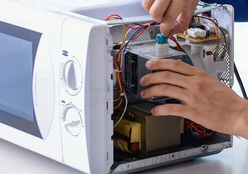 Countertop microwave oven on a kitchen shelf